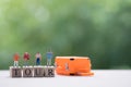 Group miniature traveler and hiker backpack standing on wooden text TOUR