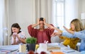 Group of misbehaving homeschooling children with teacher studying indoors, coronavirus concept.