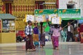 A group of hardworking Burmese women and men carrying heavy boxes on top of their head Royalty Free Stock Photo