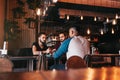 Group of mixed race young men talking in lounge bar. Multiracial friends hanging out and having fun in cafe Royalty Free Stock Photo