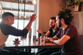 Group of mixed race young men talking in lounge bar. Multiracial friends having fun in cafe Royalty Free Stock Photo