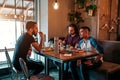 Group of mixed race young men talking in lounge bar. Multiracial friends having fun in cafe Royalty Free Stock Photo