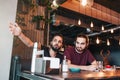 Group of mixed race young men talking in lounge bar. Multiracial friends having fun in cafe Royalty Free Stock Photo