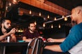 Group of mixed race young men talking and laughing in lounge bar. Multiracial friends having fun in cafe. Guys hang out Royalty Free Stock Photo