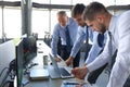 Group of modern business men in formalwear analyzing stock market data while working in the office Royalty Free Stock Photo