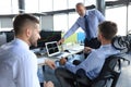 Group of modern business men in formalwear analyzing stock market data while working in the office Royalty Free Stock Photo