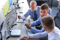 Group of modern business men in formalwear analyzing stock market data while working in the office Royalty Free Stock Photo