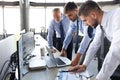 Group of modern business men in formalwear analyzing stock market data while working in the office Royalty Free Stock Photo