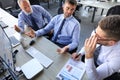 Group of modern business men in formalwear analyzing stock market data while working in the office Royalty Free Stock Photo