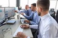 Group of modern business men in formalwear analyzing stock market data while working in the office Royalty Free Stock Photo