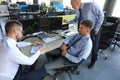 Group of modern business men in formalwear analyzing stock market data while working in the office Royalty Free Stock Photo