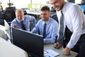 Group of modern business men in formalwear analyzing stock market data while working in the office Royalty Free Stock Photo