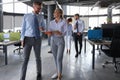 Group of modern business people are talking and smiling while standing in the office hallway Royalty Free Stock Photo