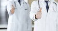 Group of modern doctors standing as a team with thumbs up or Ok sign in hospital office, close-up. Medical help Royalty Free Stock Photo