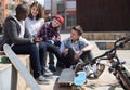 Group of modern teens chatting in the yard