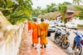 Group of monks on a city street, in Louangphabang, Laos. Copy space for text.