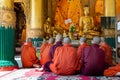 Group of monks praying at Shwedagon pagoda in Yangon, Burma Myanmar