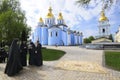 Monks standing near the church, St. Michael Golden-Domed Monastery on a background. April 27, 2018. Kiev, Ukraine