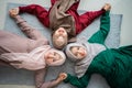 Group of moslem female friends smiled while laying on the mattress