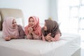 Group of moslem woman lying on the bed enjoy chatting together