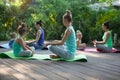 Group of mothers and daughters doing exercise practicing yoga outdoors Royalty Free Stock Photo