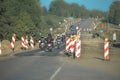 Group of motorcyclists driving over a under construction zone Royalty Free Stock Photo