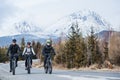 Group of mountain bikers riding on road outdoors in winter. Royalty Free Stock Photo