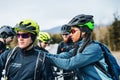 Group of mountain bikers standing on road outdoors in winter, talking. Royalty Free Stock Photo