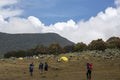 a group of mountain climbers crossing an open area in the surrounding mountains Royalty Free Stock Photo