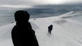 Group of mountain climbers going up icy slope with ski poles. Clip. Amazing adrenaline hobby, concept of sport, two Royalty Free Stock Photo