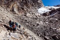 Group of Mountain Climbers walking on rocky slope toward Pass Royalty Free Stock Photo