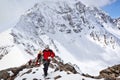 Group of mountaineers ascent to the mountain using the rope on a complex slope is composed of rock and snow Royalty Free Stock Photo