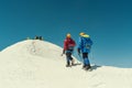 Group of mountaineers climbing in the snowy mountain peaks.