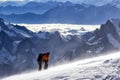 A group of mountaineers climbs to the top of a snow-capped mountain Royalty Free Stock Photo