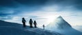 A group of mountaineers climbs to the top of a snow-capped mountain Royalty Free Stock Photo