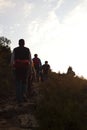 Group of mountaineers hiking in in a sunset