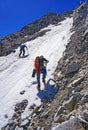 Group of mountaineers make the ascent of the mountain on snow-covered hillside plot