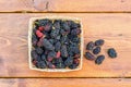 Group of mulberries isolated on wood. Royalty Free Stock Photo