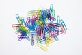 A group of multi-colored paperclips pile up on white background Royalty Free Stock Photo