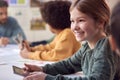 Group Of Multi-Cultural Students With Teacher In Classroom Using Digital Tablet In Lesson Royalty Free Stock Photo