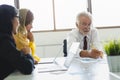 Group of multi ethnic business people in the meeting room reviewing audit documents on the table Royalty Free Stock Photo