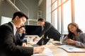 Group of multi ethnic busy people working in an office, Aerial view with businessman and businesswoman sitting around a Royalty Free Stock Photo