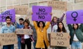 Group of multi-ethnic feminism activist protesting for women empowerment holding banners. No means no movement.