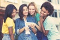 Group of multi ethnic girls watching movie clip at cellphone Royalty Free Stock Photo