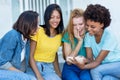 Group of multi ethnic  girls watching movie clip at cellphone Royalty Free Stock Photo