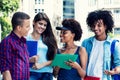 Group of multi ethnic students talking about classes Royalty Free Stock Photo