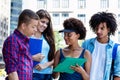 Group of multi ethnic students talking about diploma Royalty Free Stock Photo