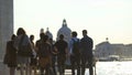 Group of multi-ethnic tourists walking in Venice, view of Grand Canal, tourism