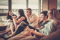 Group of multi ethnic young friends having fun in home interior Royalty Free Stock Photo
