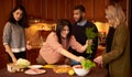 Group of multi ethnic young friends in kitchen prepare for party Royalty Free Stock Photo
